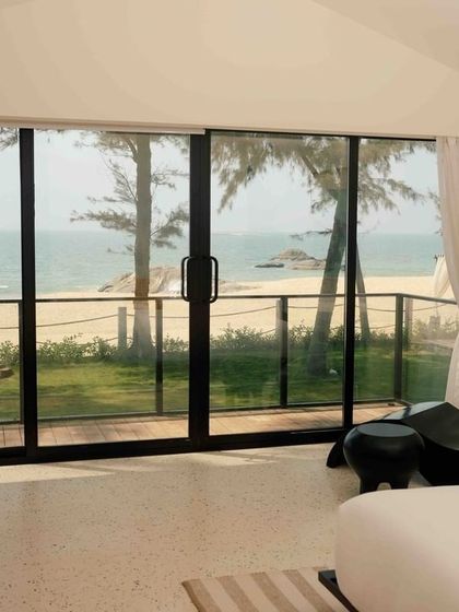 The bedroom at The Postcard Arabian Sea, Maravanthe Beach, opens up to an uninterrupted view of the ocean. This is a secluded, luxury oasis for a perfect coastal retreat.