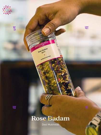 Holding a jar of my Rose Badam Desi Mukhwas. This after-meal ritual is crafted with fragrant rose petals, roasted almonds, and fennel to aid digestion and keep your breath fresh naturally.