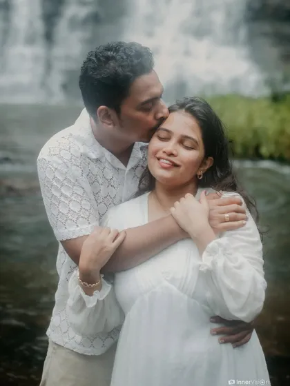 A tender forehead kiss by the waterfall. This close-up shot is filled with emotion, capturing a moment of love, care, and protection.