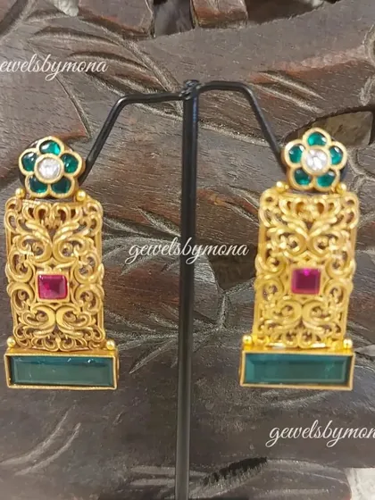 From my Dakshinaya collection, these earrings feature intricate gold filigree work, a floral top, and are accented with ruby and emerald-colored stones. They capture the essence of traditional temple jewellery.