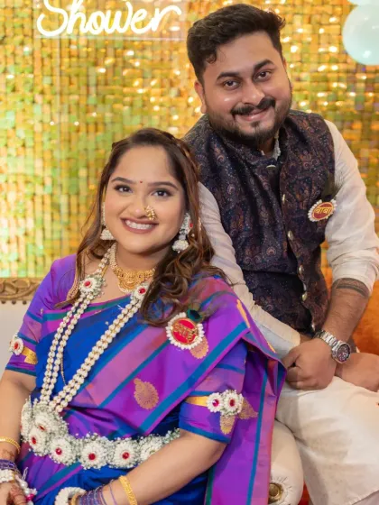 A happy couple at their baby shower. Her makeup is bright and celebratory, perfect for this joyous milestone.