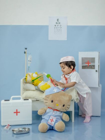 The little doctor in action, giving her patient an injection.