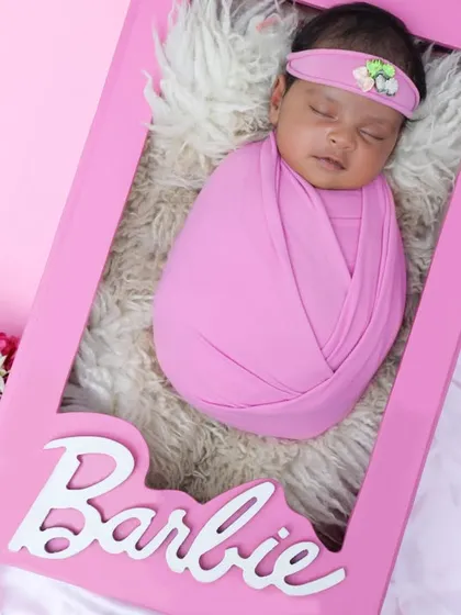 Come on Barbie, let's go party! This creative newborn shoot places your little doll in her very own life-sized Barbie box for a unique and unforgettable portrait.