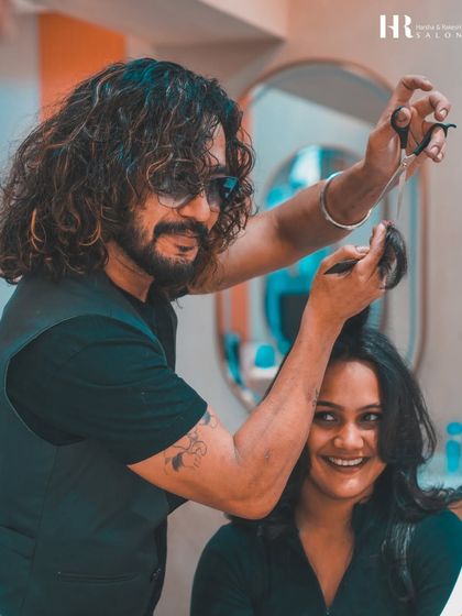 A happy client during her haircut, enjoying the friendly and professional atmosphere of the salon.