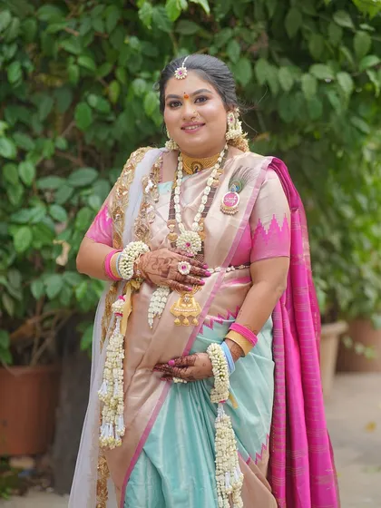A full view of the baby shower attire, showing how the long floral necklace, haath phool, and kamarband create a complete and elegant look.