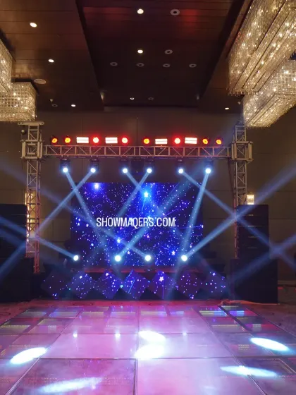 A stunning stage and dance floor setup for a ring ceremony. The LED screen with cosmic visuals and dynamic spotlights created an electrifying atmosphere for the evening's celebrations.