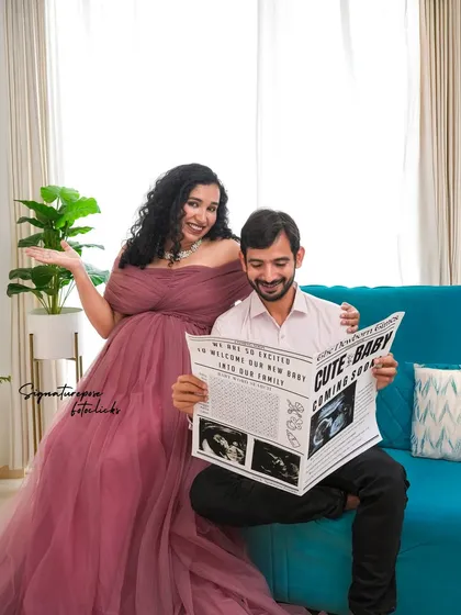 Let's have some fun with your announcement. Using creative props like this custom "Newborn Times" newspaper adds a playful and personal touch to your maternity session, making the memory even more special.