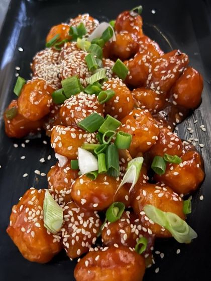 Our chef's special Waterchestnut Honey Chili with a twist. It's crispy, sweet, and tangy, garnished with spring onions and sesame seeds for extra flavor.
