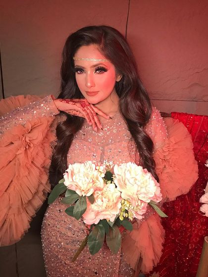 This pose highlights the intricate henna design and the soft, glowing makeup, creating a perfect blend of tradition and modernity.