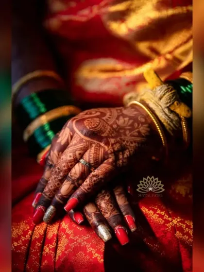 An artistic shot focusing on the bride's hands. The dark, rich stain and intricate patterns are the centerpiece of this beautiful photo.