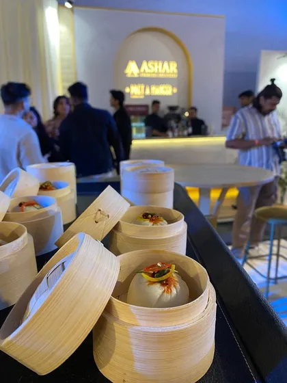 Shanghai Vegetable Bao Buns, served in individual bamboo steamers, ready to be enjoyed by guests at the Ashar Group event.