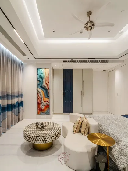 This angle shows the custom wardrobe with its integrated blue panel, tying the design together. The vibrant wall art adds a splash of color and personality, making the room feel unique and curated.