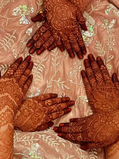A group of friends showing off their beautiful, matching henna stains. It's so much fun to get mehndi done together.
