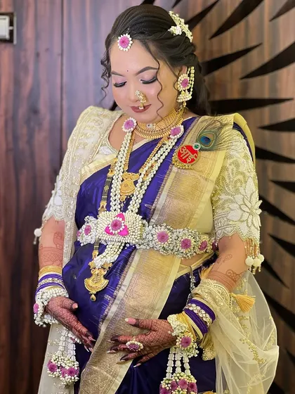 A full view of the mom-to-be cradling her baby bump, adorned in the complete pink and blue floral jewellery set.