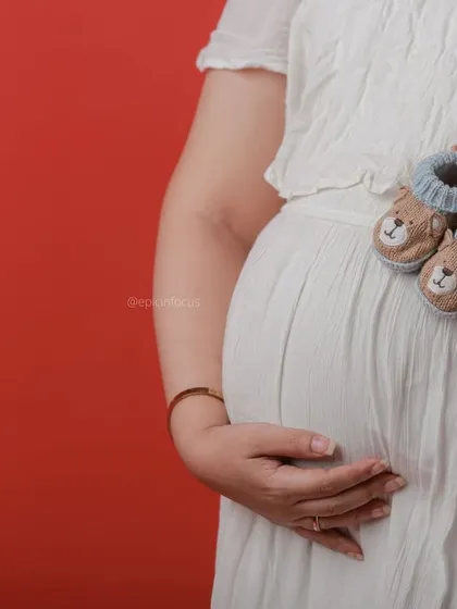 Tiny knitted booties are another sweet prop we provide to symbolize the little one on the way.