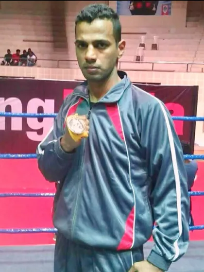 A photo from my early days, holding a medal after a win. The journey of a fighter is long, and I have walked every step of it.