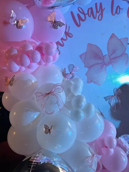 We love adding delicate details, like these small bows and butterfly stickers on the balloons, to enhance the theme.
