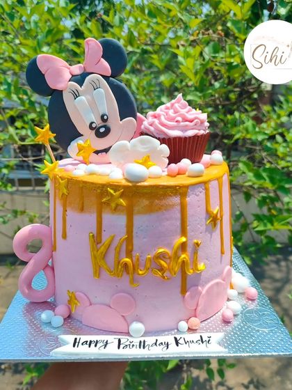This Minnie Mouse cake is pure therapy to make. The pink drip cake is adorned with a large Minnie Mouse topper, a mini cupcake, and gold stars for a magical 8th birthday.