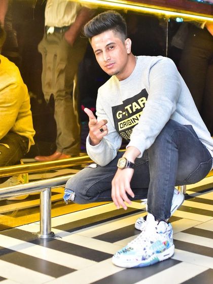 Crouching down for a quick photo during a set. The black and white striped floor is almost as iconic as the beats.