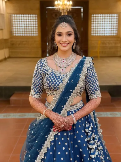 A direct portrait of the client, her happy smile lighting up the frame.