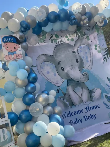 A closer view of the outdoor elephant-themed welcome home setup. The large, cute elephant backdrop is perfect for a fun and playful celebration.