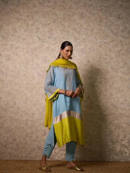 A striking combination of powder blue and lime green. This color-blocked kurta set is modern, fresh, and perfect for making a statement at a daytime event.