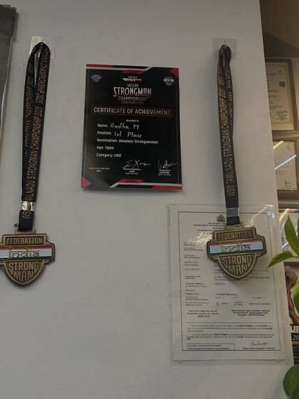 My certificate and medals from the Strongman Championship, proudly displayed at the gym. They serve as a daily reminder of what's possible with hard work and dedication.