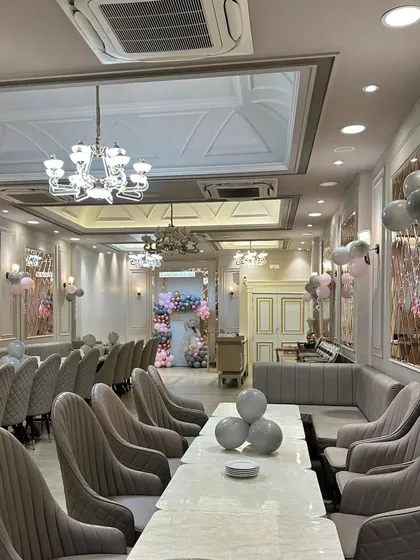 We believe in decorating the entire space to create a cohesive experience. For this half-birthday party, we placed small balloon clusters on the tables to match the main backdrop.