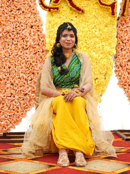 A full view of my haldi look, complete with a bandhani blouse and floral jewelry. Your outfit can inspire the choreography, whether it's a playful skirt twirl or a graceful dupatta move.
