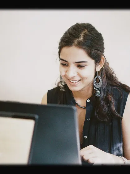 A customer smiling at her laptop screen. We love seeing people happy and focused in the environment we've created.