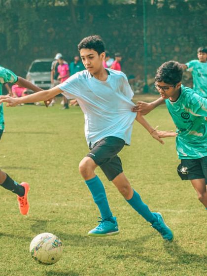 Three players converge on the ball, a moment of intense action from a Pride Cup game.