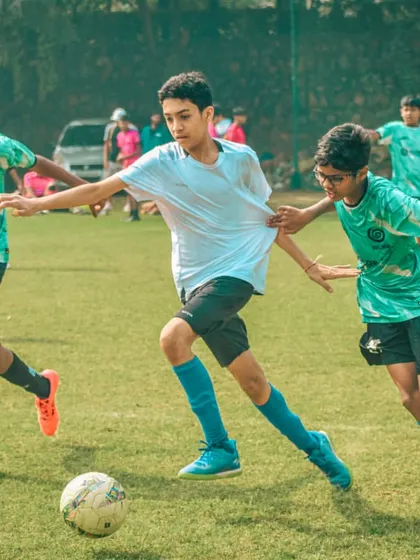 Three players converge on the ball, a moment of intense action from a Pride Cup game.