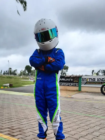 A young driver in his full gear, ready for a training session.