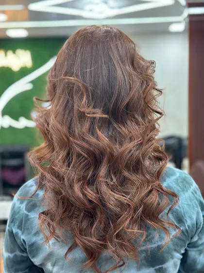 The back view of this stunning global color, with curls that cascade down her back.