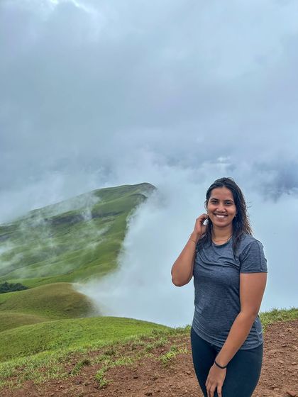 A smiling trekker enjoying the cool, cloudy weather on the Netravathi trail.