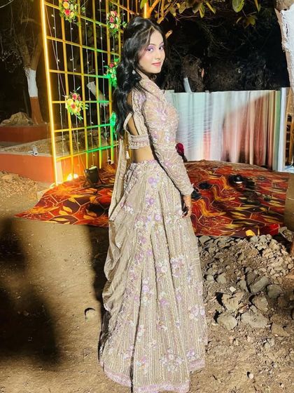 A back view of the beige and purple floral lehenga, showing its elegant cut and design.