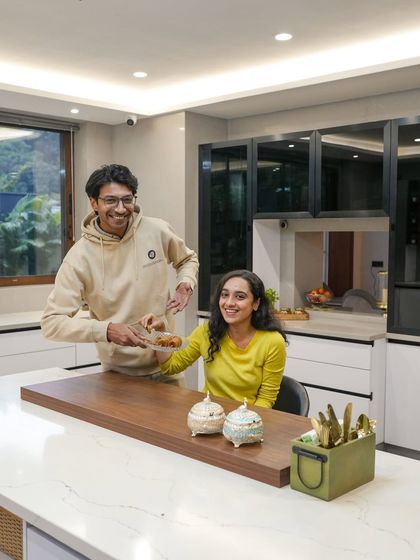 Prachi and Prashant Jain enjoying their new kitchen island. This image captures the essence of our goal: to create spaces that bring families together.