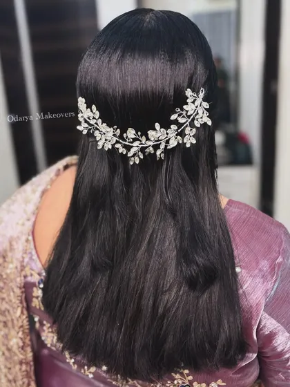 An elegant open hairstyle for the mother of the bride at the reception. The crystal hair accessory adds a touch of glamour.