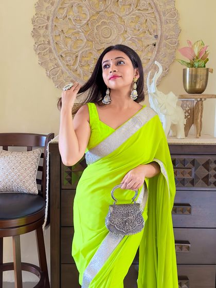 A candid moment showing the flow of the georgette fabric. This saree is almost 10 years old, proving that a well-designed piece is truly timeless.