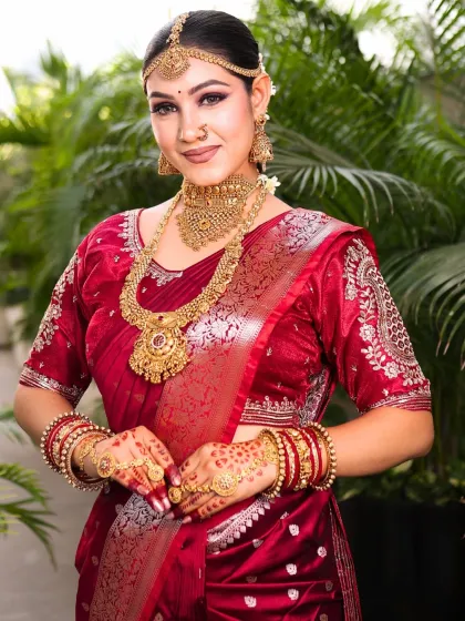 This bride's pose highlights her intricate henna and stunning temple jewelry. The makeup is kept clean and radiant to ensure the focus remains on these beautiful traditional elements.