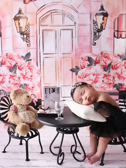 A little dream of Paris. This unique newborn setup features a Parisian café scene, complete with a tiny table and a teddy bear companion. It’s a whimsical theme that tells a sweet story.