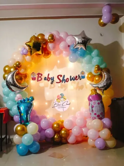 A whimsical 'Twinkle Twinkle Little Star' themed baby shower with a pastel balloon ring and moon-shaped foil balloons.