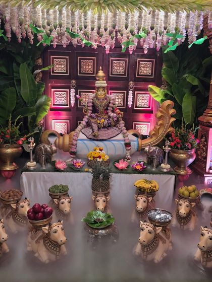 A mystical setup featuring a large Lakshmi idol with a dry ice fog effect creating a heavenly atmosphere.