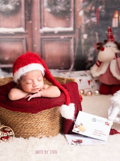 Santa's newest and cutest little helper. This Christmas-themed shoot captures the magic of a baby's first holiday season.
