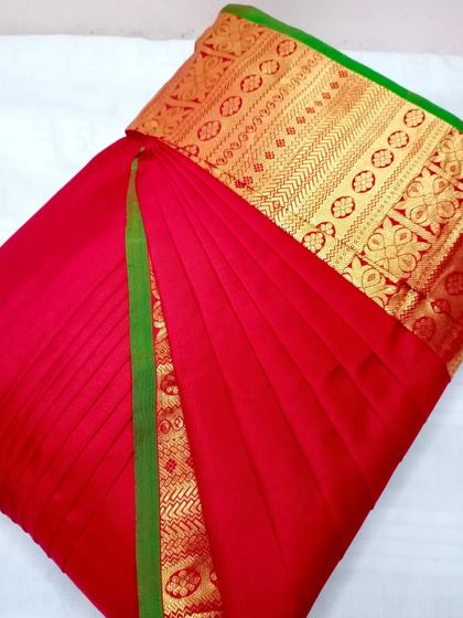 A bright red saree with a green and gold border. Try my pre-pleating service and you'll love how easy it is to drape your favorite sarees.