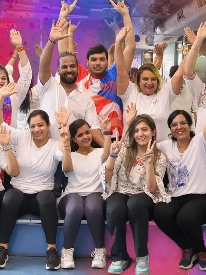 Our community is everything. This is a shot from our Holi celebration, one of the many times we come together to celebrate life, not just burn calories.