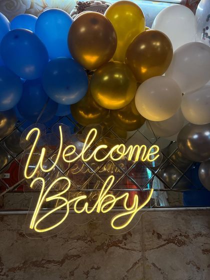 A simple but classic 'Welcome Baby' neon sign, which can be used as a standalone piece or as part of a larger balloon backdrop.