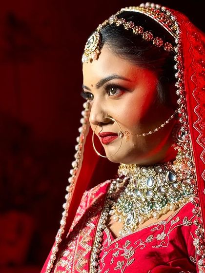 A side profile of my bride Himanshi. The red lighting highlights her sharp features and the beautiful details of her nath.