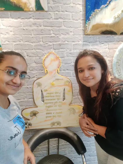 The joy of creating is doubled when I can share it with others. Here I am with a happy student at my workshop, proudly displaying the beautiful Navkar Mantra wall decor she made for her new home.