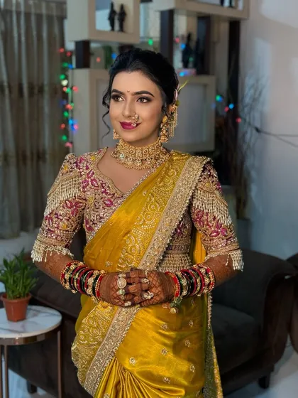 A portrait of the bride in her yellow Nauvari, looking elegant and poised.